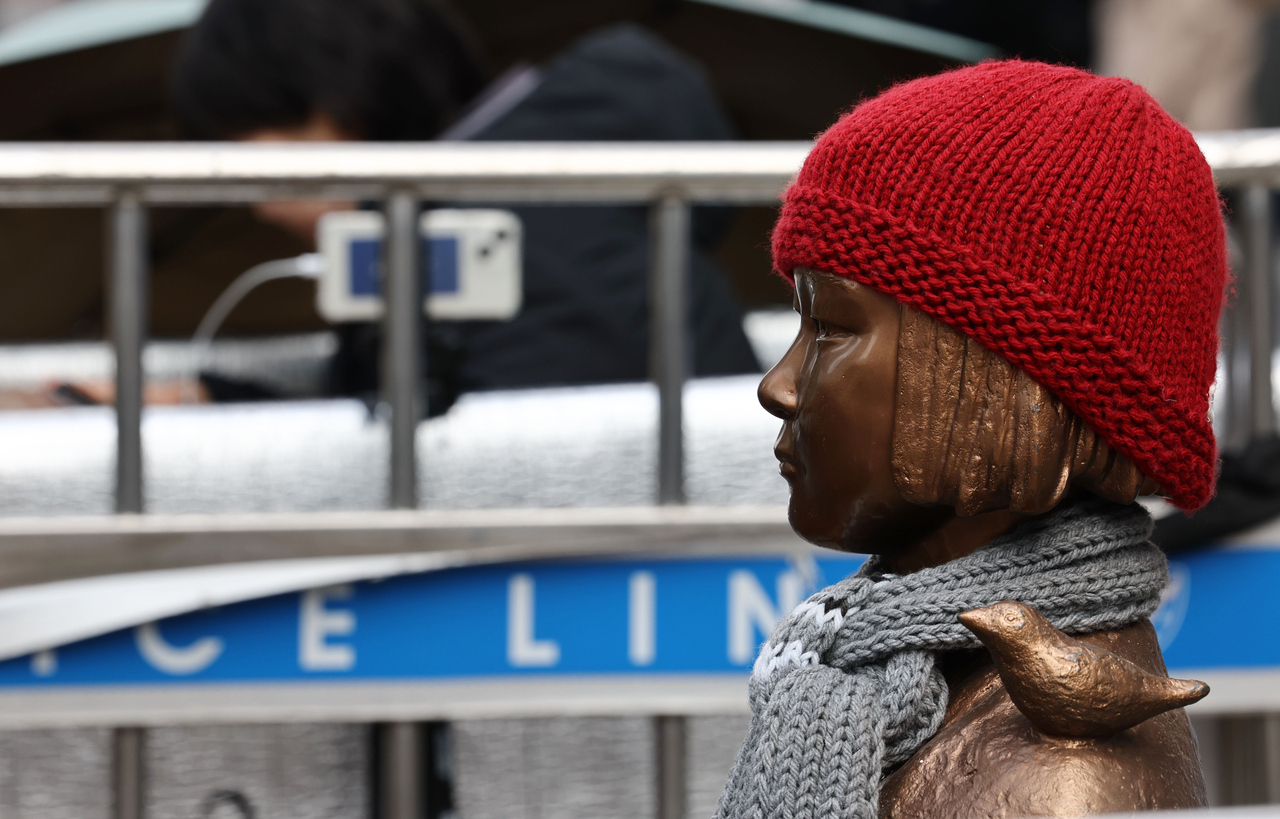This photo taken Feb. 28, 2025, shows a comfort women statue with a red hat on in central Seoul. (Yonhap)