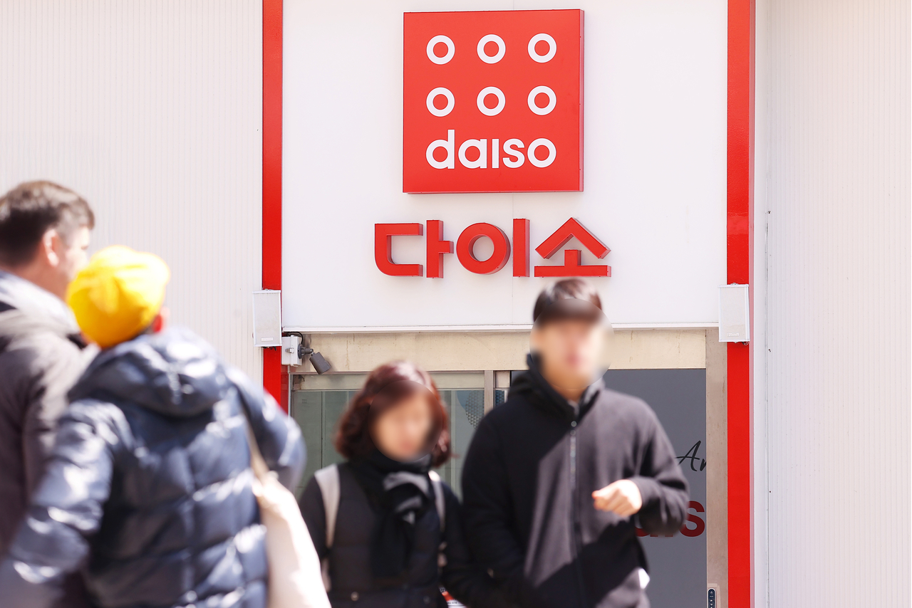 People walk past a Daiso store in Seoul on April 15. (Yonhap)